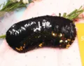 Close-up detail of reversible black and gold sequins on a mermaid-style sleep mask - Black + Gold