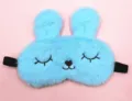 Detailed view of a cute light blue plush bunny sleep mask with soft fur texture and ears. - Squinty Eye Rabbit / Blue