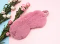Close-up of a soft pink plush sleep mask featuring a fuzzy faux rabbit fur texture - Deep Pink