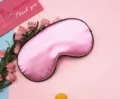Soft pink imitation silk sleep eye mask with black piping for comfortable light blocking - Pink