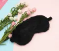 Close-up of fluffy black plush sleep mask with soft texture and elastic strap - Black