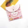 Detailed view of the cute pink puppy sanitary napkin storage pouch with Smile text - Pink