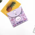 Macro view of cute purple cartoon rabbit storage pouch with snap button closure - Purple