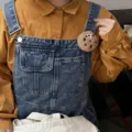 Close-up of cute cookie plush brooch pinned on denim overalls for accessory display - Brooch / Light Coffee (Sad Face)