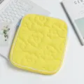 Detail shot of a yellow quilted iPad sleeve featuring flower patterns and blue zipper - 24*2*30cm / Yellow