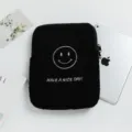 Black plush iPad sleeve with white smiley face embroidery shown next to a tablet. - 11" / Black Smiley Face