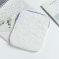 Close-up view of a white quilted floral tablet sleeve featuring a stylish purple zipper accent - 24*2*30cm / White