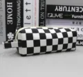 Detail view of the black and white checkerboard pencil case with side handle. - Handheld Pencil Case - Black White Grid