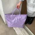 Purple double-layer PVC tote bag featuring a floral cutout design and clear outer layer - Purple