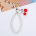 Close-up detail of sweet red cherry and white pearl bead chain keychain accessory - Silver Tone Solid Red Cherry
