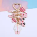 Detailed view of pink medical theme charms on a heart-shaped golden keychain - Pink