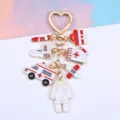 Detailed view of a zinc alloy medical keychain with ambulance and thermometer charms - Red White