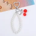 Close-up of sweet cherry and pearl chain keychain pendant with heart-shaped clasp - Silver Tone Clear Red Cherry
