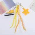 Detailed view of yellow mini canvas shoe keychain with braided climbing rope and star charm - Yellow