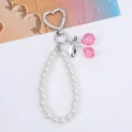 Close-up of a sweet cherry pearl chain keychain featuring heart-shaped clasp and pink beads - Platinum Tone Pink Cherry