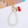 Sweet cherry and pearl bead keychain with golden heart-shaped clasp and leaf detail - Gold Double Cherry