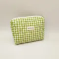 Detailed macro view of green and white checkered quilted cosmetic bag with brand tag label - 24*20*6cm / Green/White