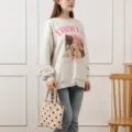 Detail of a retro corduroy polka dot tote bag held by a person in a casual outfit - New Corduroy Beige Polka Dot Handbag