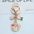 Vue détaillée d'un porte-clés thème marin avec fleurs de cerisier roses et étoile de mer - Rose Coquille