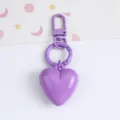 Close-up of a candy purple resin heart keychain pendant with a matching carabiner - Purple