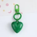 Close-up detail of vibrant green candy-colored resin heart keychain with matching ring - Dark Green