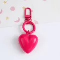 Close-up detail of a vibrant hot pink resin heart keychain pendant with matching metal ring - Rose Red