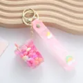 Cute pink liquid quicksand bubble tea keychain featuring a rainbow strap with wish design - Liquid Milk Tea Cup / Pink