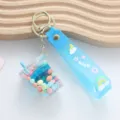 Cute blue boba tea liquid quicksand keychain featuring a soft PVC strap and colorful beads - Liquid Milk Tea Cup / Blue