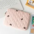 Detailed view of cute pink quilted tablet bag featuring black embroidered bow decorations - 13" / Pink