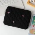 Close-up of quilted black laptop sleeve with cute pink bow embroidery details - 13" / Black