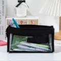 Detailed view of a large capacity black mesh pencil case filled with stationery items - Black