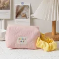 Close-up of pink quilted cosmetic bag with yellow handle for makeup storage - Light Pink