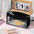 Close-up detail of a large capacity transparent black mesh pencil case with stationery - Regular / Black