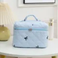 Light blue quilted cosmetic bag with black bow embroidery on white vanity table with lamp - 23*16*16cm / Light Blue