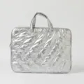 Detailed view of a silver metallic quilted laptop bag with decorative butterfly stitching - 15 Inch / Silver Bow