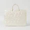 Close-up of cream quilted heart pattern laptop sleeve with top handles - 15 Inch / Off-White Heart Style