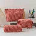 Knitted makeup bag and pencil case set featuring an orange and pink striped checkerboard pattern - Three-Piece Set / Orange Red