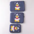 Detailed view of three grey-blue tablet sleeves with cute embroidered cartoon duck design - 11" / Blue Duck