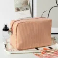 Detailed view of large orange striped seersucker travel makeup bag on vanity tray - 22*9*15cm / Orange