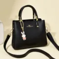 Elegant black top-handle bag for women with cute rabbit charm and gold hardware - Black