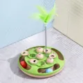 Interactive pet slow feeder turntable toy with green feather and moving balls. - Ping Pong Treat Puzzle Toy / Green