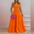 Conjunto elegante de dos piezas para mujer con top corto naranja y falda maxi larga con volantes. - S / Set de dos piezas / Naranja
