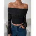 Top nero in pizzo con spalle scoperte e maniche lunghe, impreziosito da un raffinato motivo floreale. - XS / Nero