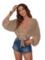 Close-up detail of women solid color deep V-neck tie front beach cover up lantern sleeve shirt. - XS / Khaki