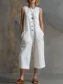 Close-up detail of white sleeveless linen wide-leg jumpsuit front button pocket design. - S / White