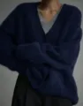 Detailed view of the cozy navy blue fuzzy V-neck cardigan showcasing soft knitted texture. - S / Navy Blue