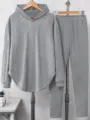 Detail shot of the solid grey hooded sweatshirt and long pants loungewear set on a display rack. - S / Top And Bottom / Light Gray