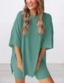 Detail shot showing the loose casual short-sleeve top and shorts two-piece set in sage green. - XS / Set / Lake Green