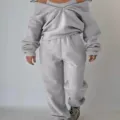 Grey fleece tracksuit for women featuring a zip-up off-shoulder sweatshirt and sweatpants. - Light Gray