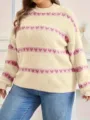 Detailed view of women's round neck knit sweater with pink heart stripes in beige color. - XL / Nude